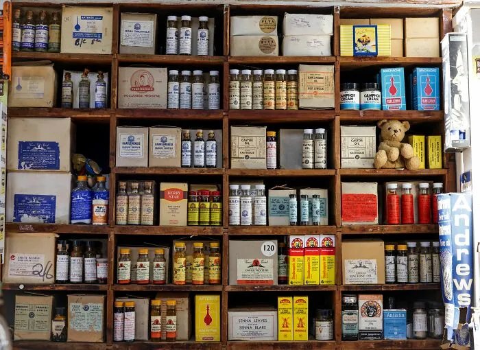 Shelves of an old apothecary filled with medicine bottles and vintage secrets to share