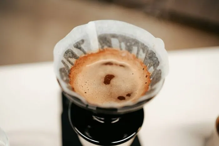 Coffee brewing in a pour-over filter, showcasing brilliant tips for a better morning routine.