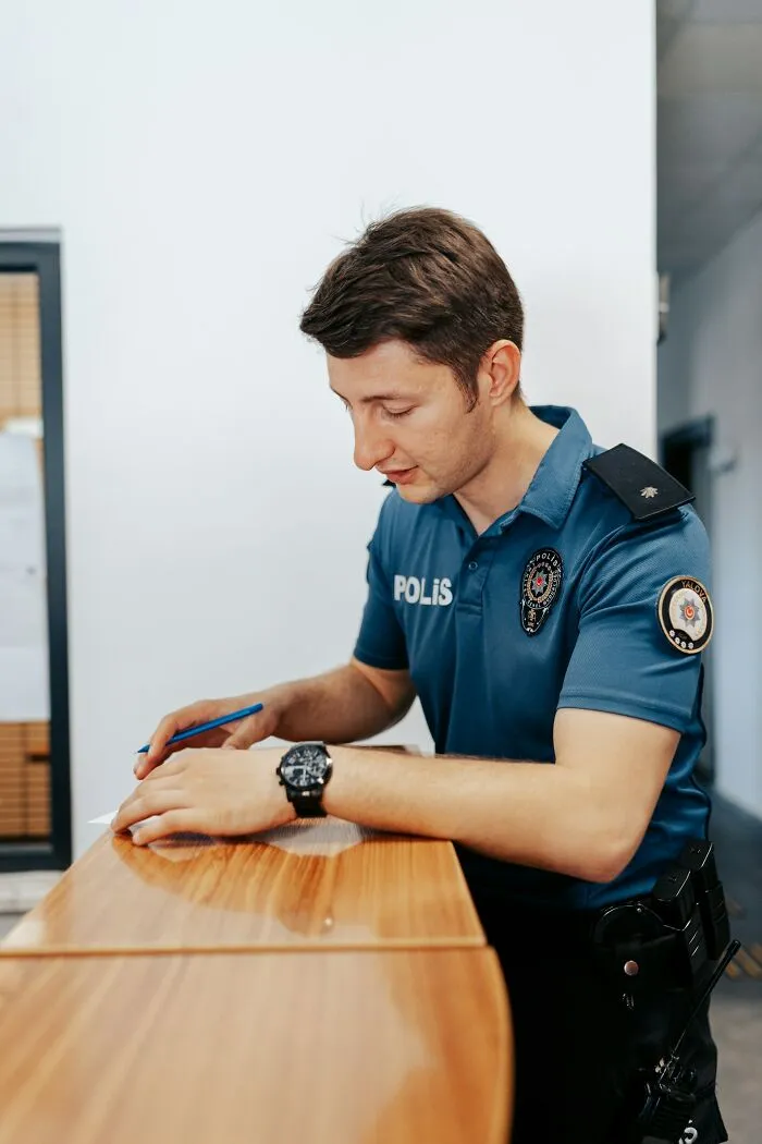 Police officer filling out paperwork, a common figure in unbelievable school rumors