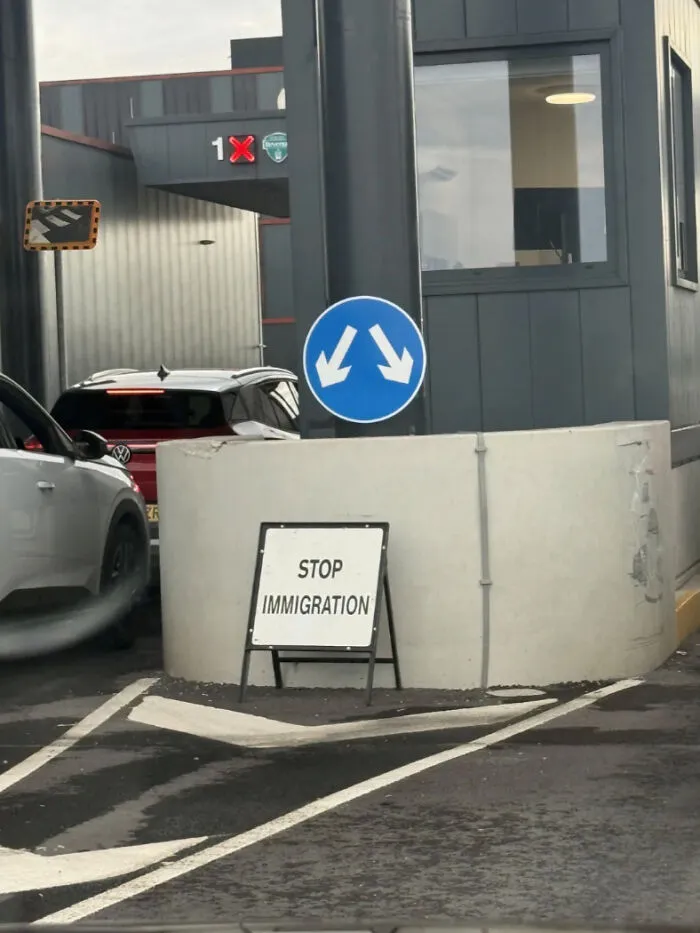 Confusing immigration stop sign with unclear traffic directions at checkpoint