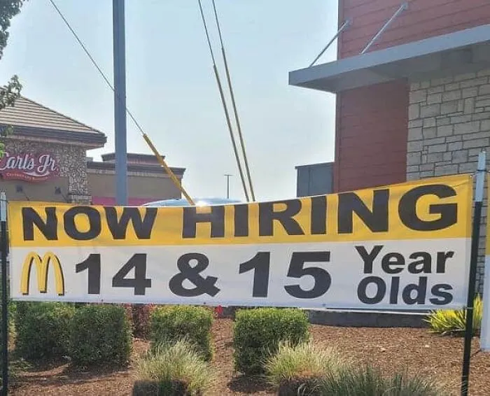 A McDonald's hiring banner for 14 and 15 year olds, illustrating modern life in America.