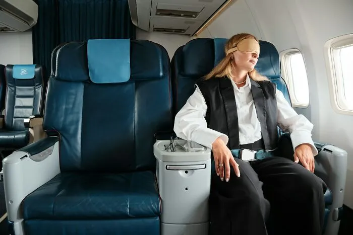 A woman sleeping in first class with an eye mask during long flights