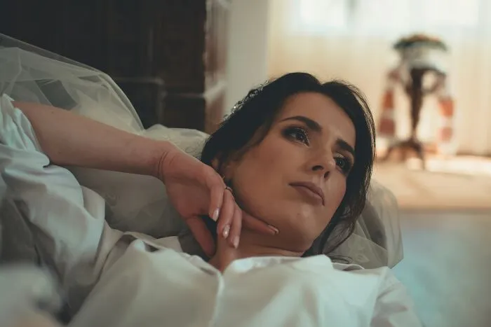 A thoughtful bride in a white shirt representing women's bodies
