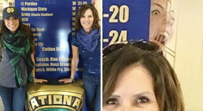 Scary face in the background of a photo with two women standing in front of a blue billboard.