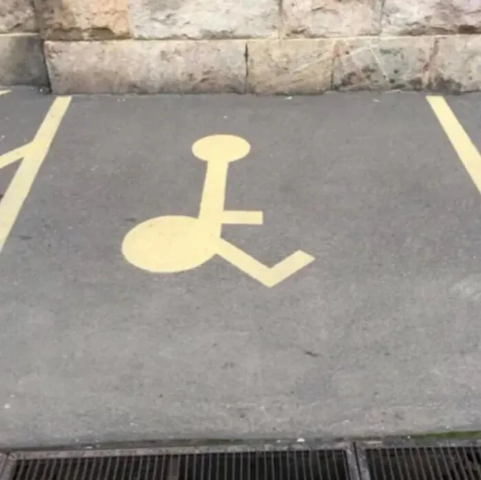 incorrectly painted handicapped parking symbol on pavement