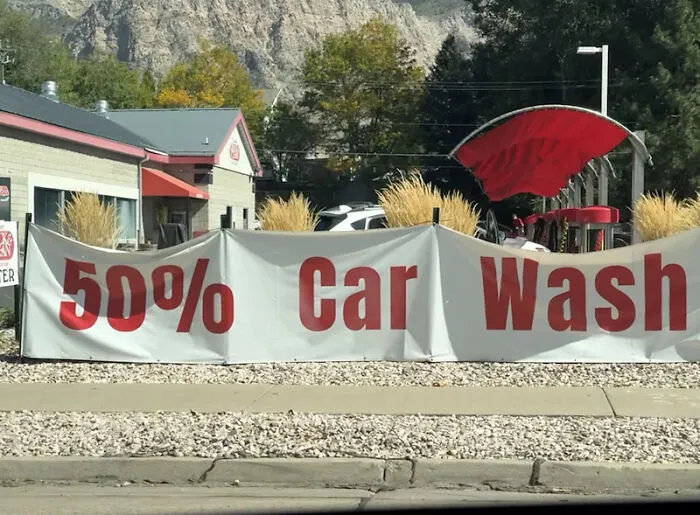 50 percent car wash banner with distorted letters outdoors