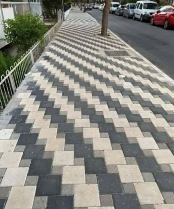Sidewalk with a confusing zigzag pattern that disrupts walking path