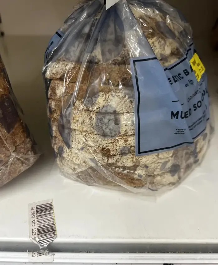 Loaf of bread in plastic bag with torn barcode underneath
