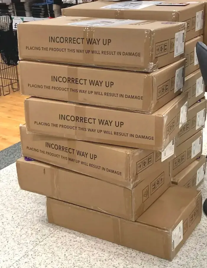 Boxes stacked incorrectly with labels stating incorrect way up causes damage