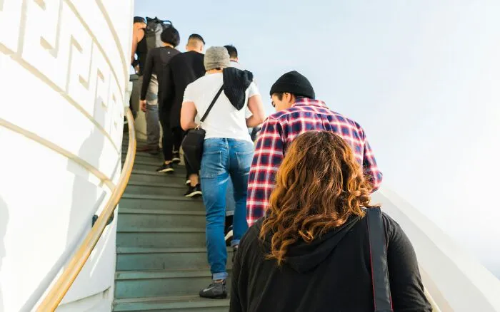 Group of people walking up stairs representing social basic life skills