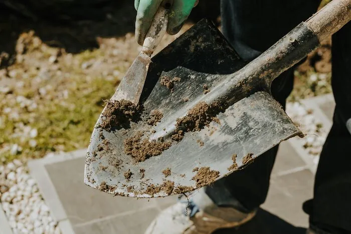A garden shovel covered in dirt, metaphorically digging deep into intelligent insults.
