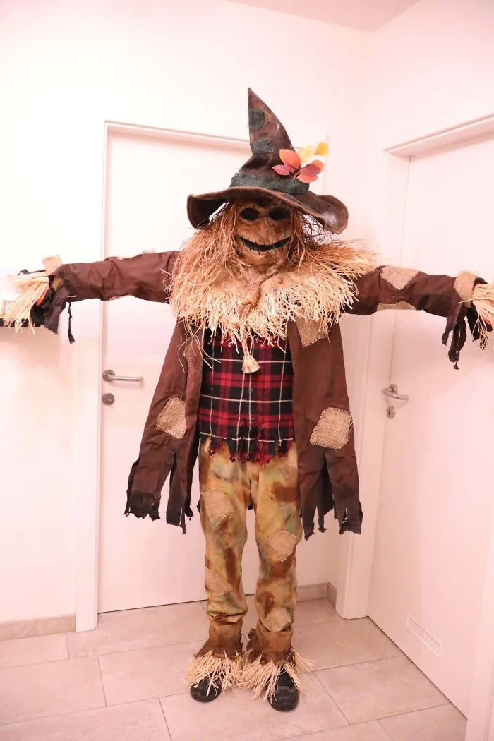 Detailed scarecrow Halloween costume with straw details and pointy hat
