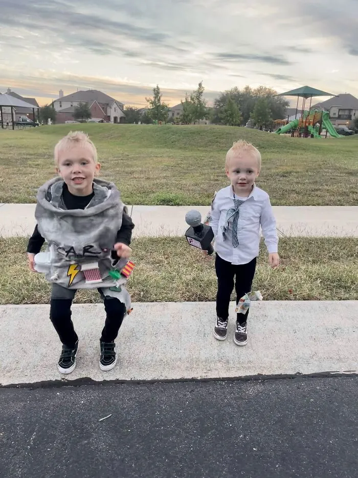 Two young kids dressed in clever DIY Halloween costumes representing a tornado and a storm reporter outdoors.