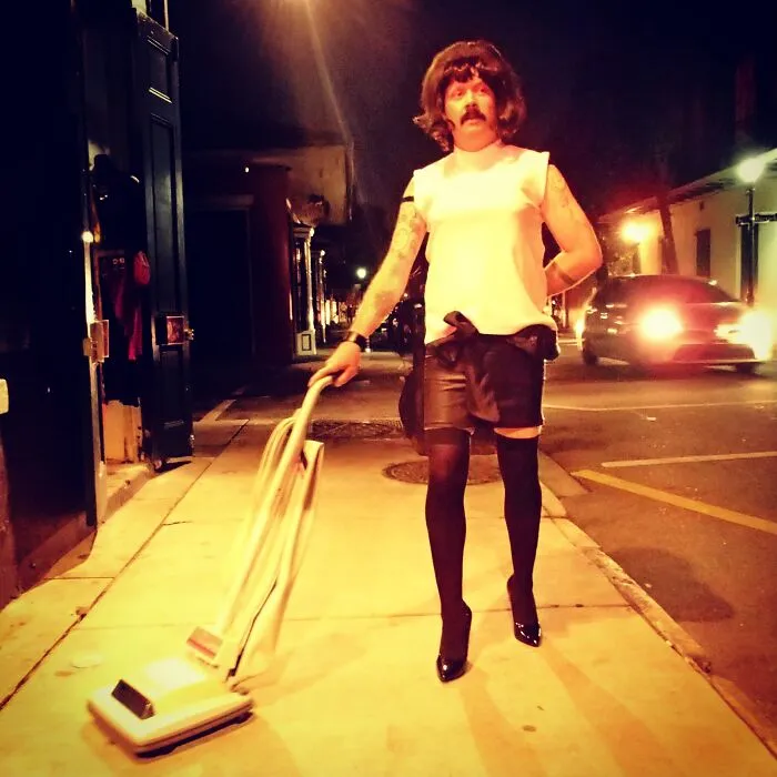 Person dressed as Freddie Mercury with vacuum cleaner for Halloween costumes