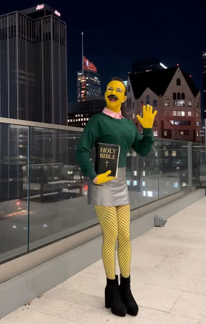 Creative Ned Flanders Halloween costume with yellow body paint and a green sweater.