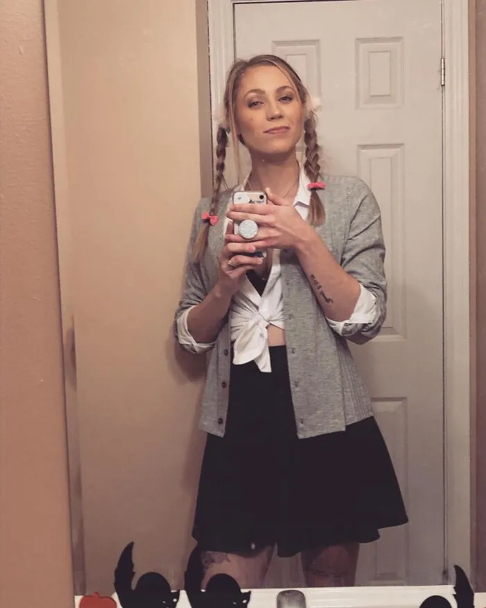 Woman posing in a schoolgirl outfit for creative Halloween costumes inspiration.