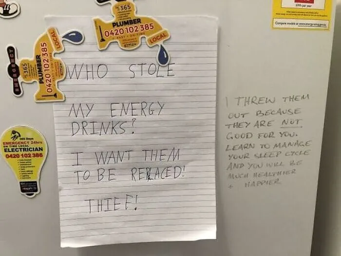 Angry note on fridge about stolen energy drinks, highlighting classic roommate stories.