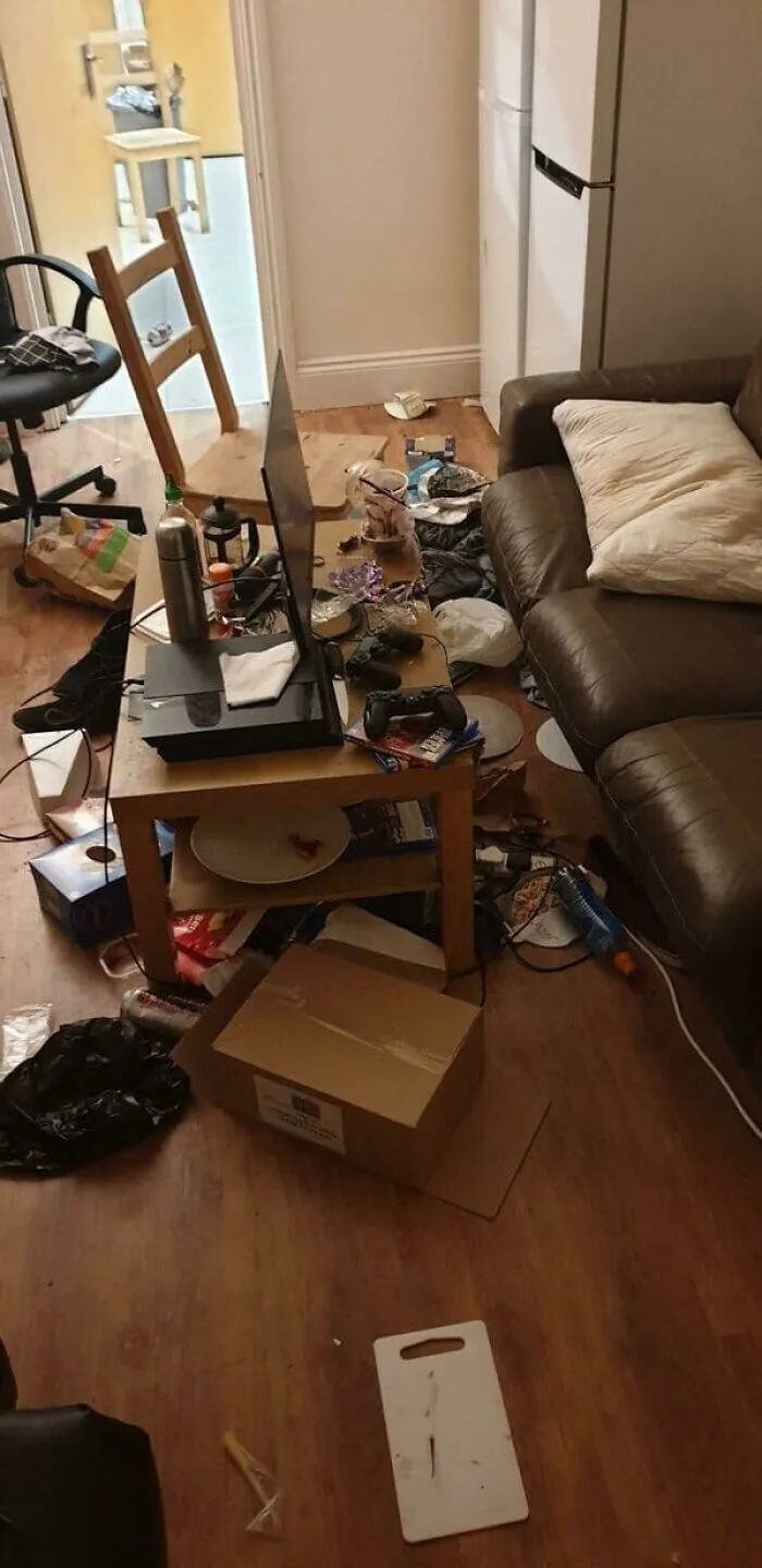 A messy living room with trash and clutter everywhere, representing bad roommate stories.
