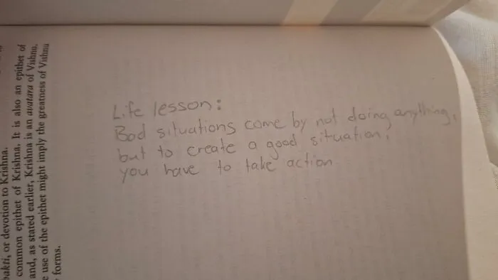 Found paper inside a book with a handwritten life lesson about taking action.