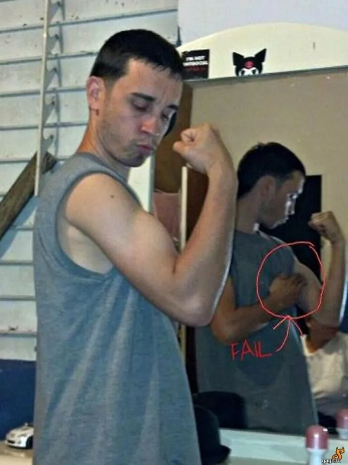 Funny mirror pic of a man flexing bicep, but mirror reflection reveals him pushing his arm muscle up.
