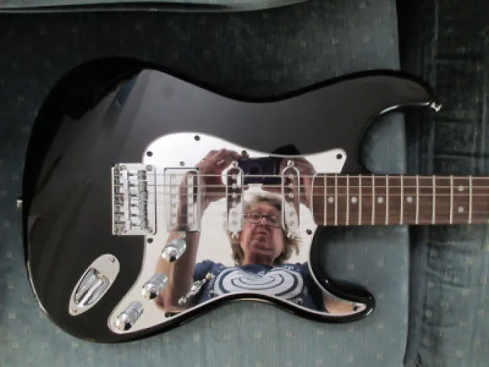 Funny mirror pics with a person taking a reflection selfie in a chrome electric guitar pickguard