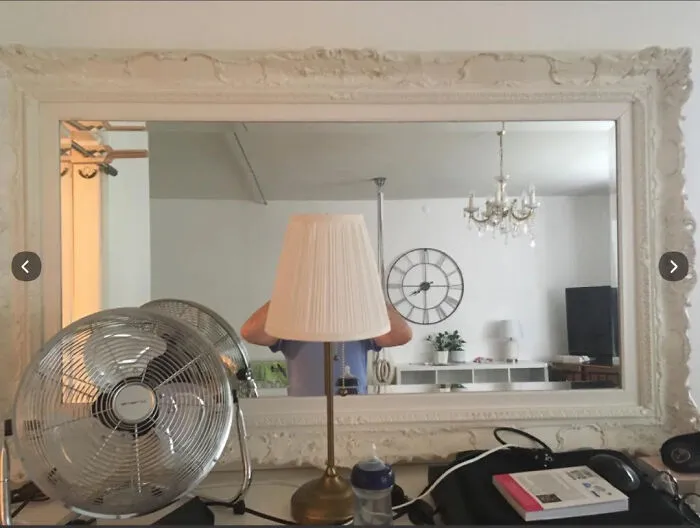 Funny mirror pics showing a lamp obscuring a person head in a large mirror