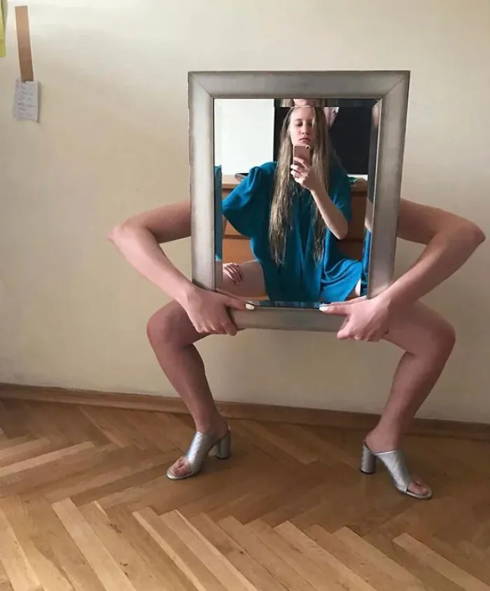 Confusing optical illusion in mirror pics showing a woman squatting with legs stretched out