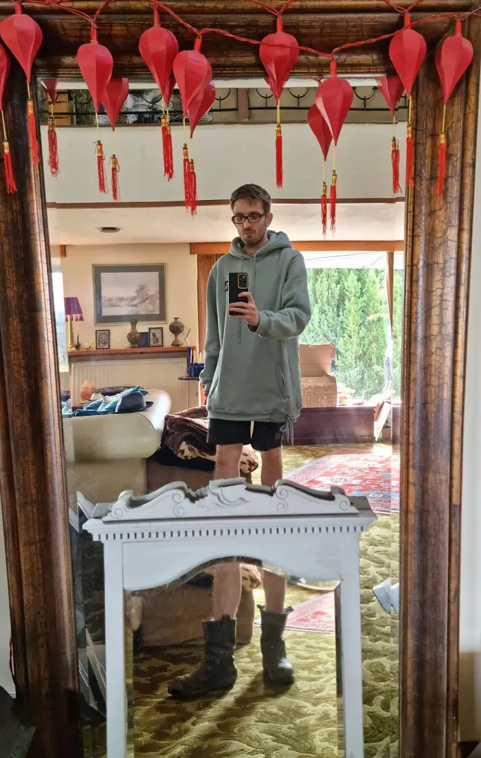 Funny mirror pics showing a layered reflection of a man taking a selfie between two mirrors.