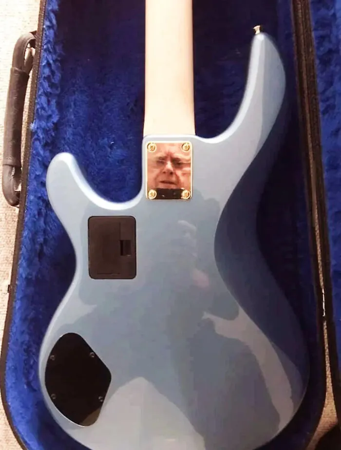 Humorous mirror pics showing an old man reflection on the back of an electric guitar