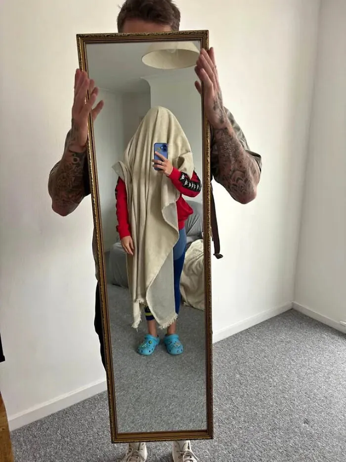 Funny mirror pics showing a person covered in a blanket holding a full length mirror