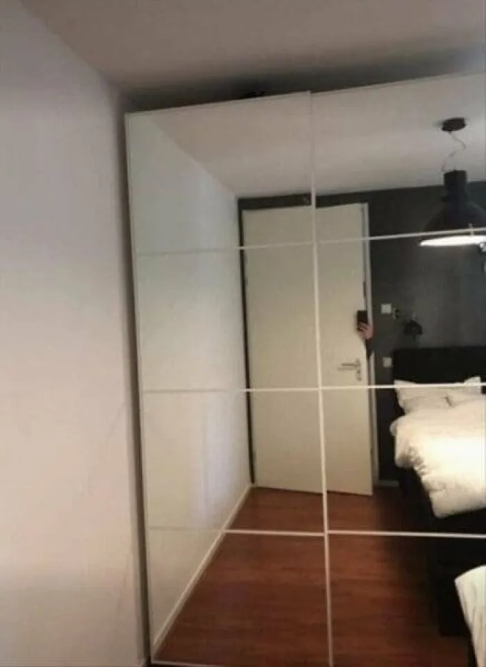 Funny mirror pics capturing a person hiding completely behind a door in a large wardrobe mirror reflection