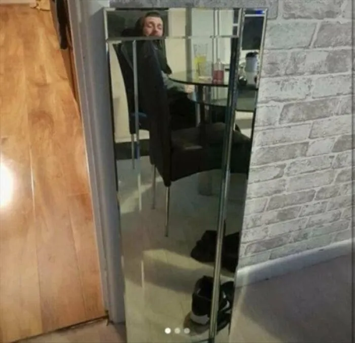Funny mirror pics displaying a man leaning backward behind a chair reflection while taking a selfie