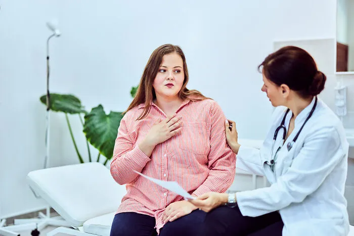 Female patient consulting doctor about health concerns