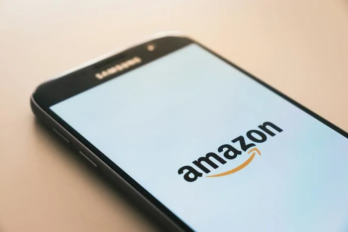 Smartphone screen displaying the Amazon logo, one of the companies people avoid