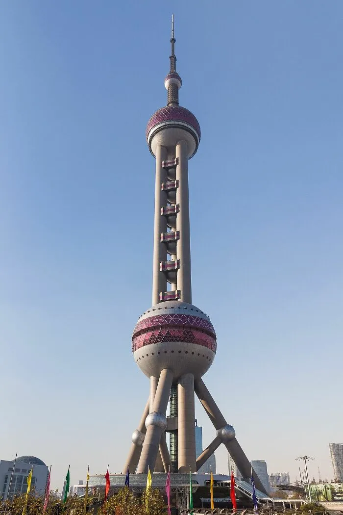 Futuristic Oriental Pearl Tower with spheres and tall spire in clear daylight
