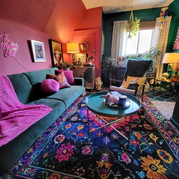 Colorful living room with vibrant rug and dark couch as part of a unique home makeover