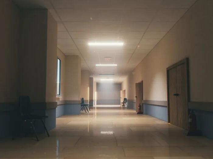 Eerie empty hallway with dim overhead lights, adding to the list of spooky things experienced by people.