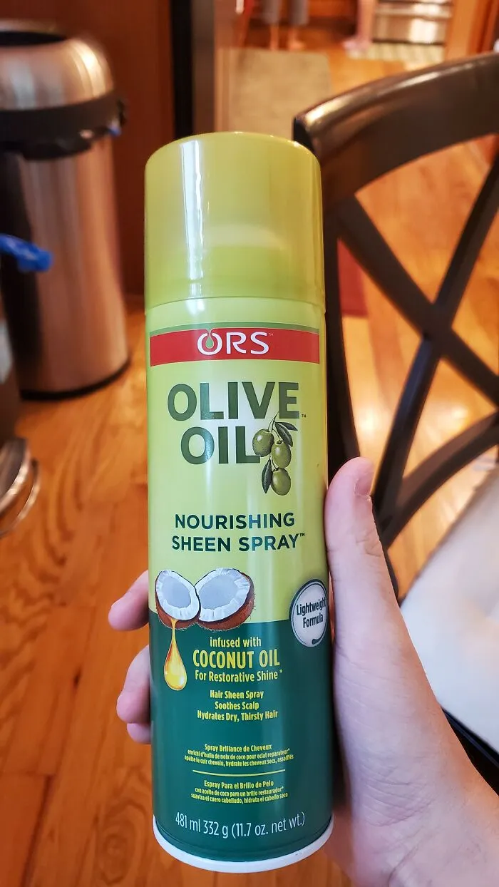 A hand holding olive oil spray with coconut oil text, showing advertising fails