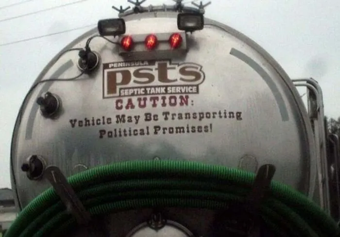 Septic tank service truck featuring funny text Caution Vehicle May Be Transporting Political Promises.