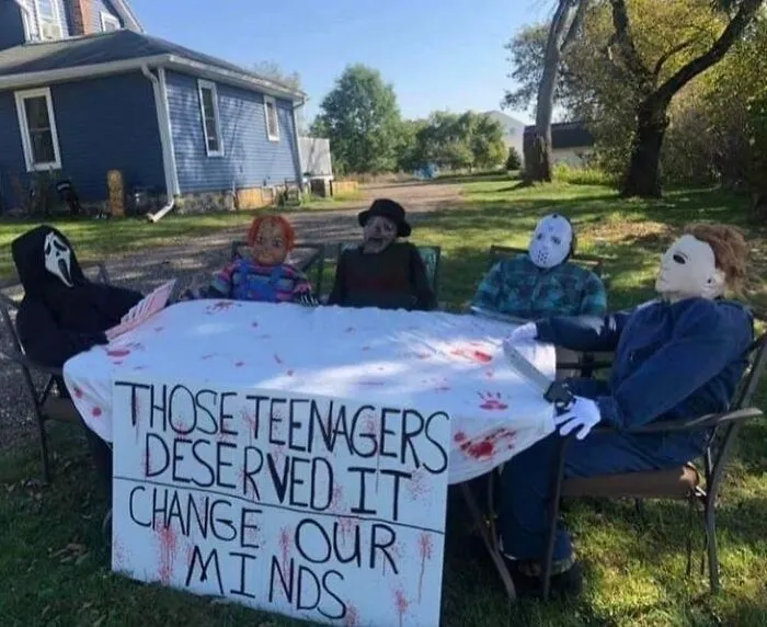 Famous horror movie villains sitting around a table as part of funny Halloween memes