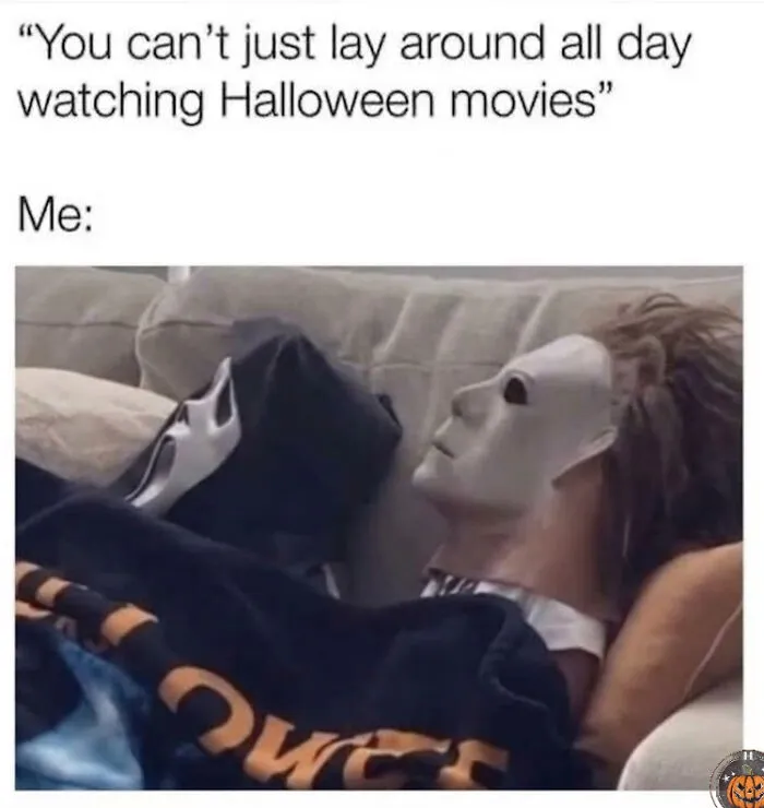 Funny Halloween meme featuring horror movie icons laying on a couch under a blanket watching TV.