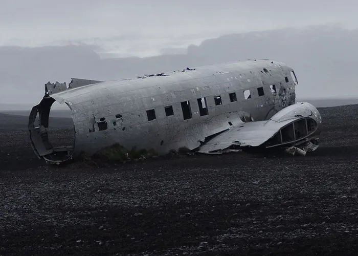A abandoned plane wreckage on a desolate landscape related to online mysteries.