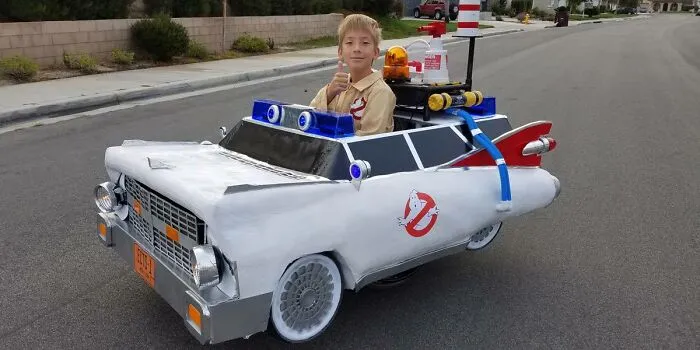 Boy in Ghostbusters Ecto-1 wheelchair costume giving thumbs up, featured among creative people with disabilities