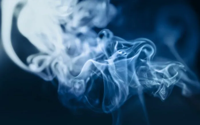 Close-up of swirling blue smoke on dark background