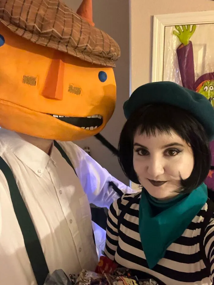 Couple dressed up as storybook characters for a unique creative Halloween costume idea.