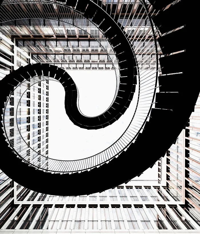 Looking up at a spiraling staircase inside a modern building, representing The Perspa Awards 2026.