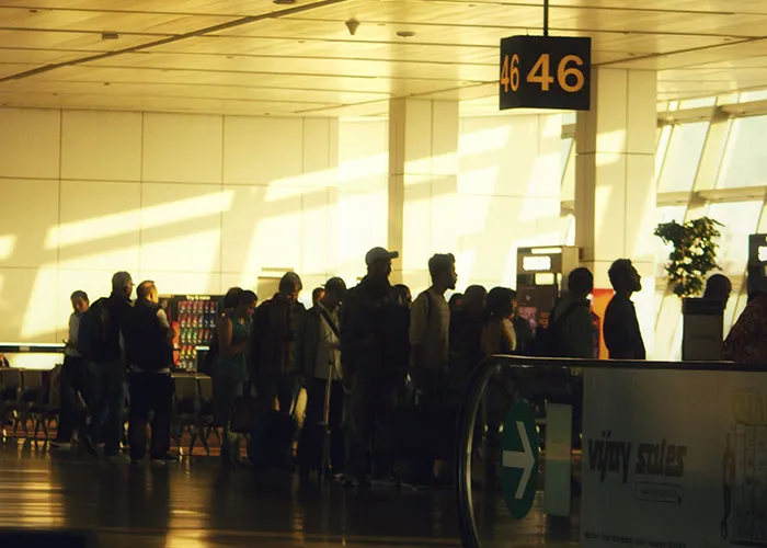 Passengers waiting in line at airport gate 46 before a flight