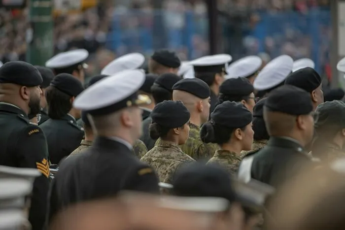 A large gathering of uniformed individuals in military berets and hats related to lesser-known cults.