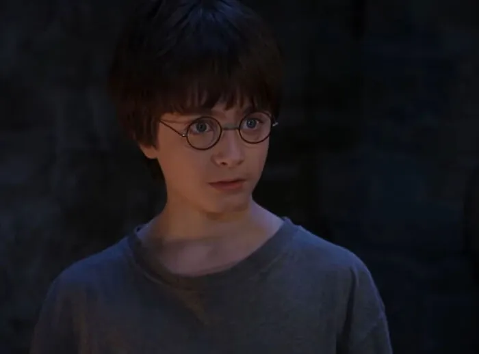 A worried boy wearing glasses, showing an intense fight or flight reaction to something a stranger said.