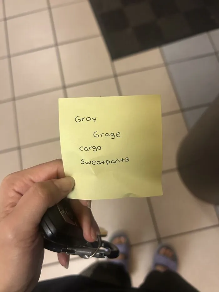 Hand holding car keys and a yellow post-it note list, representing a piece of found paper.